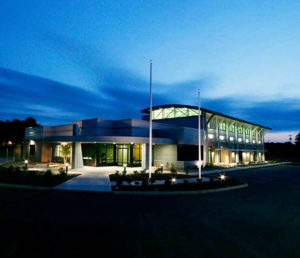 An exterior view, at night, of the newly built PIPS Technology building.