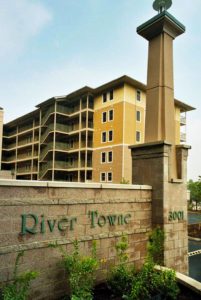 An exterior view of the River Towne Condominiums and the signage.