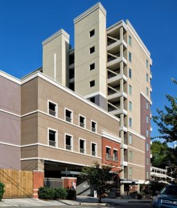An exterior view of the Lake Plaza Condominiums and private parking garage.